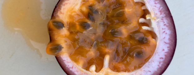 half a passionfruit on a board