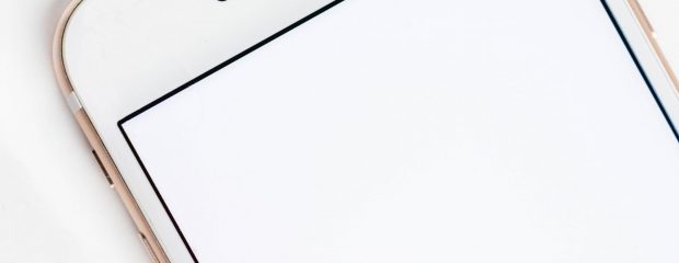 white mobile phone with youtube red and white arrow logo on screen