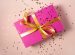 Pink rectangular gift tied with gold bow sprinkled with little gold metalic hearts - gift vouchers for naturopathy and mentoring online