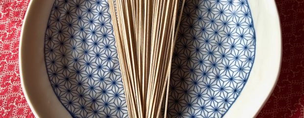 light brown coloured soba noodles fanned on a blue and white asymetrical plate on red table cloth soba noodle salad recipe Gill Stannard Naturopath Australia