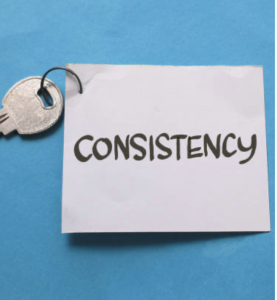 key attached tow white square of paper with consistency written in black texta