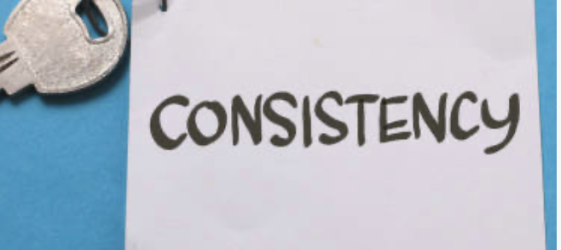 key attached tow white square of paper with consistency written in black texta