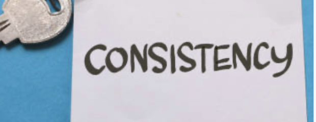 key attached tow white square of paper with consistency written in black texta